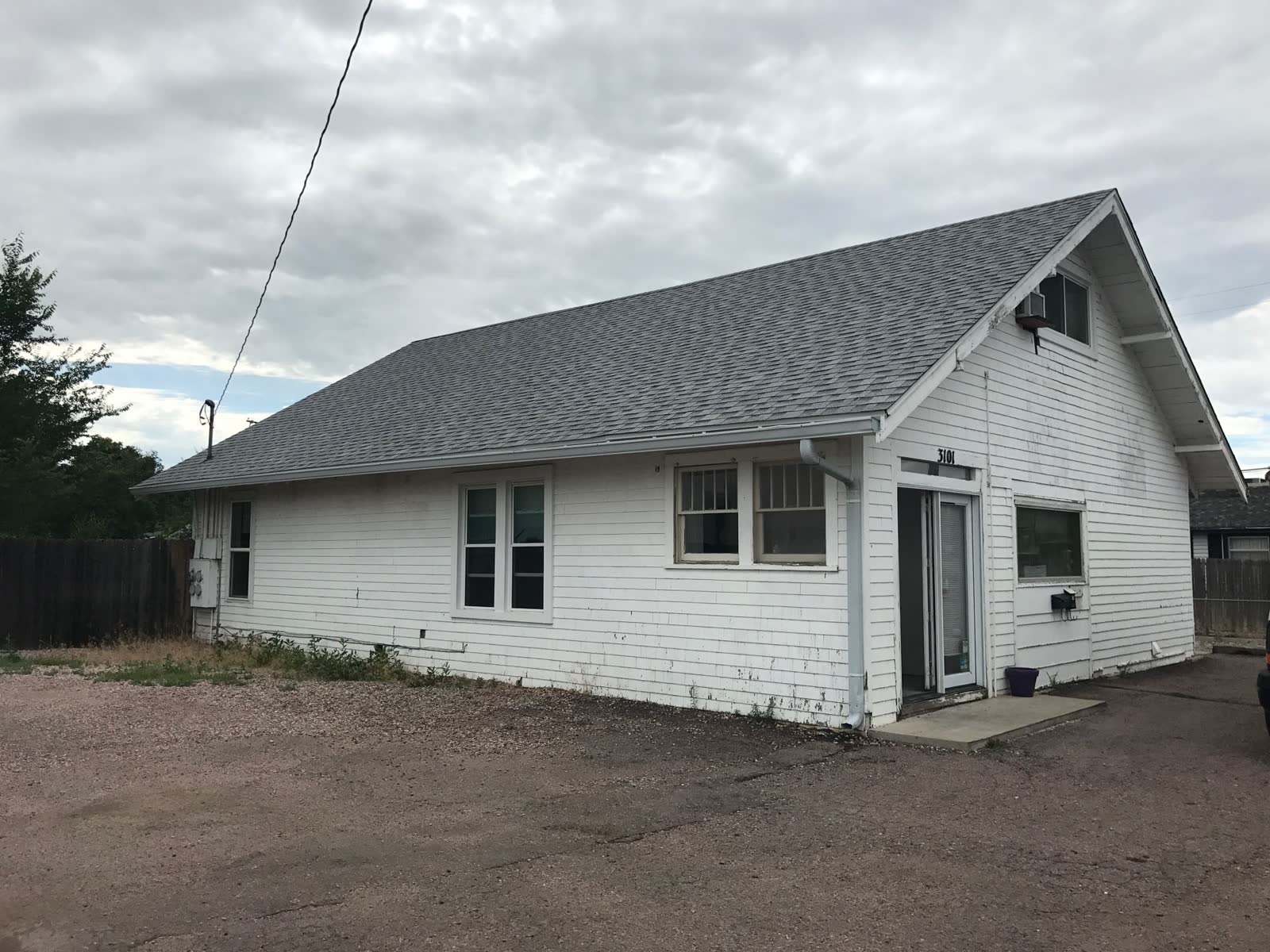 Before: aging wood-clad home with peeling paint