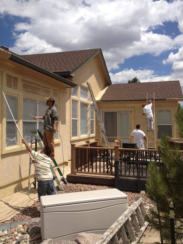 Grey-blue single-story home after exterior coating
