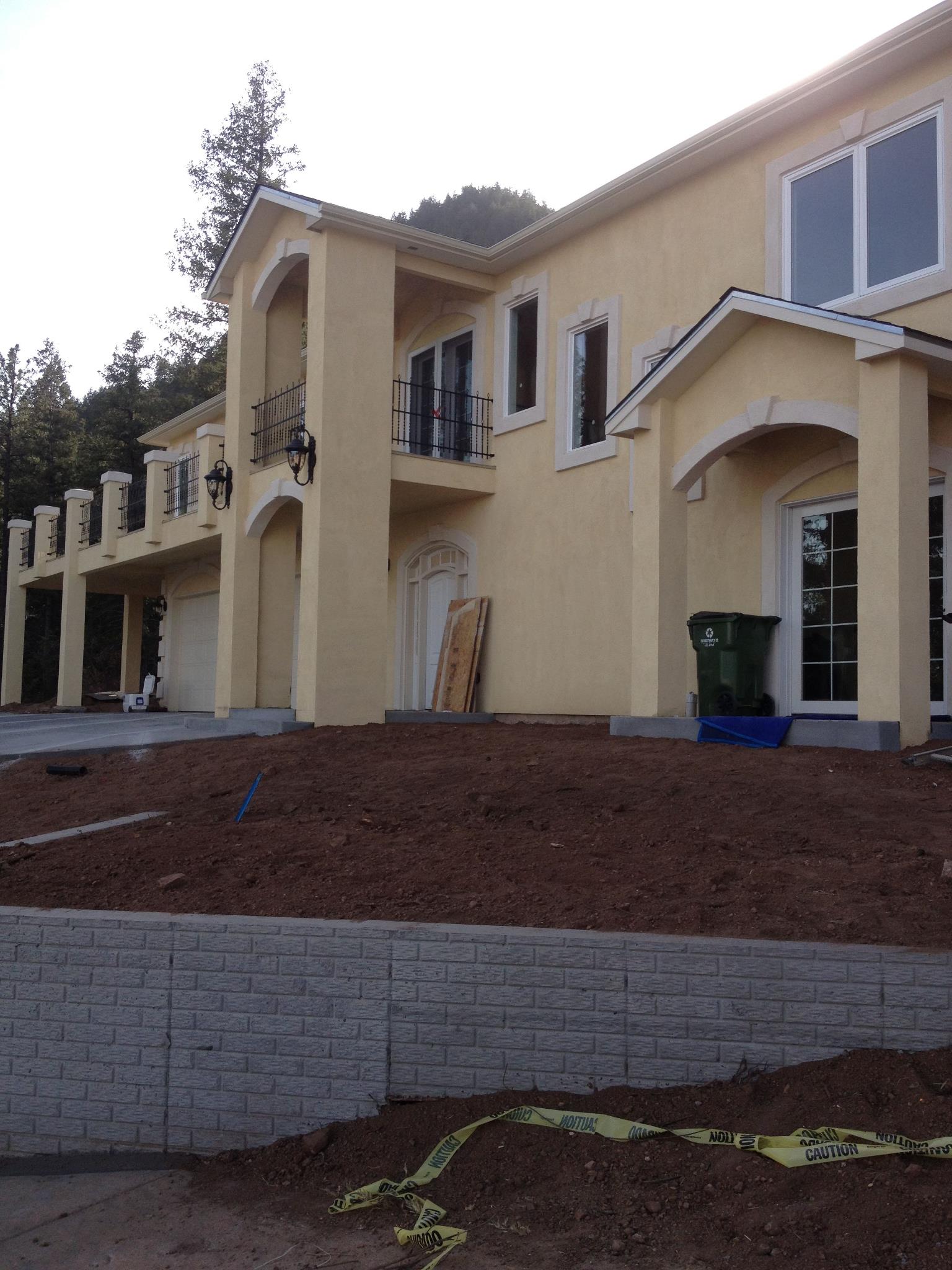 Stucco home mid-project with fresh base coat