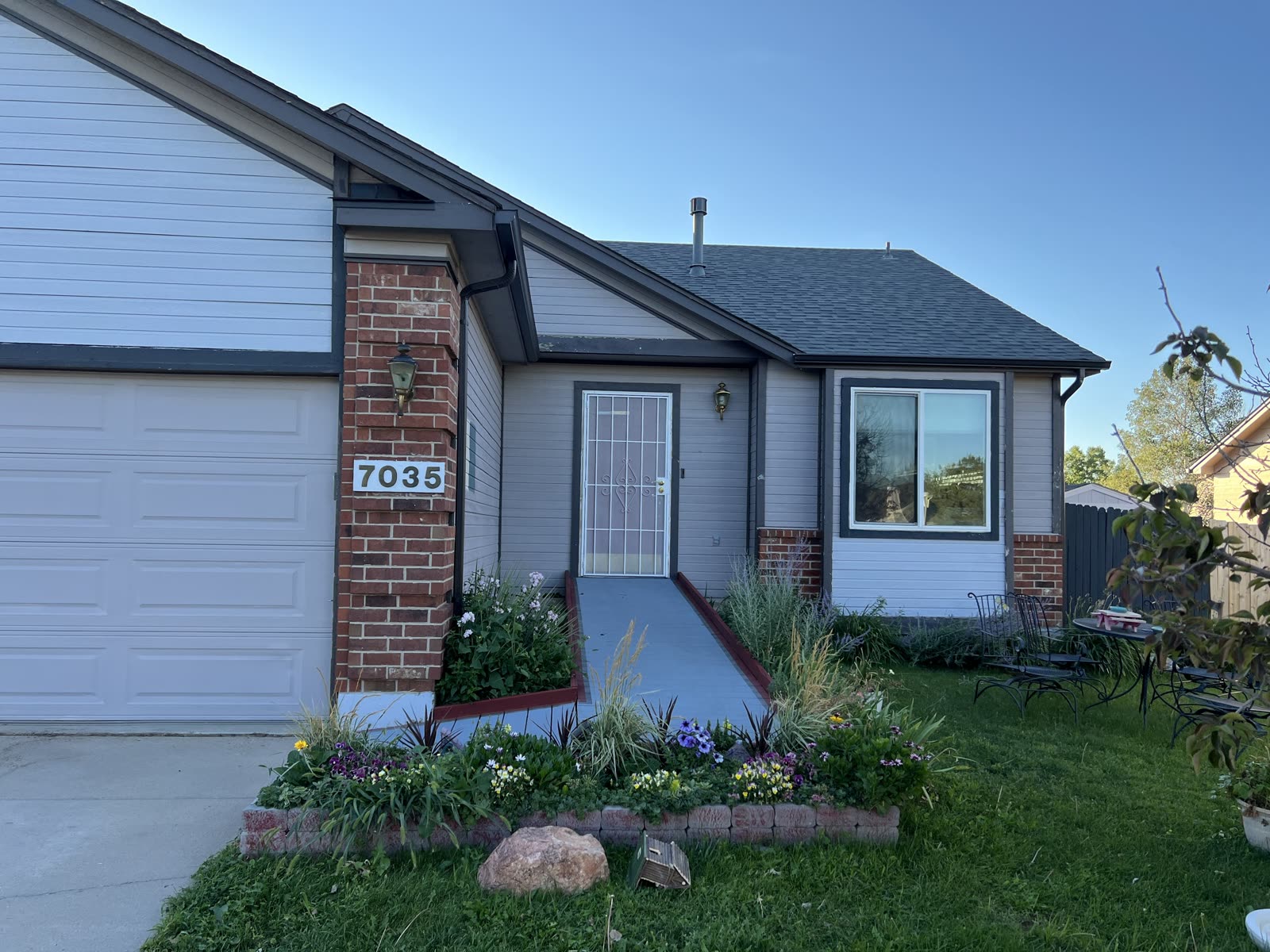 Neighborhood home with newly coated exterior and brick accent