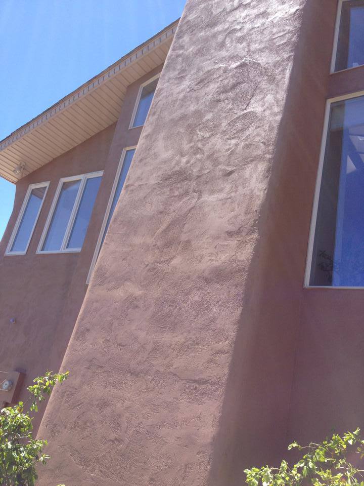 Purple-brown stucco elevation with clerestory windows